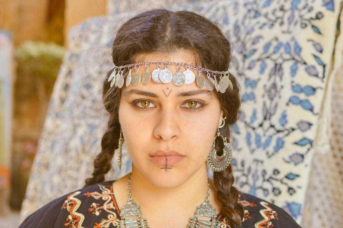 Infographic showing evolution of cornrows from ancient Nubia to modern-day CROWN Act legislation